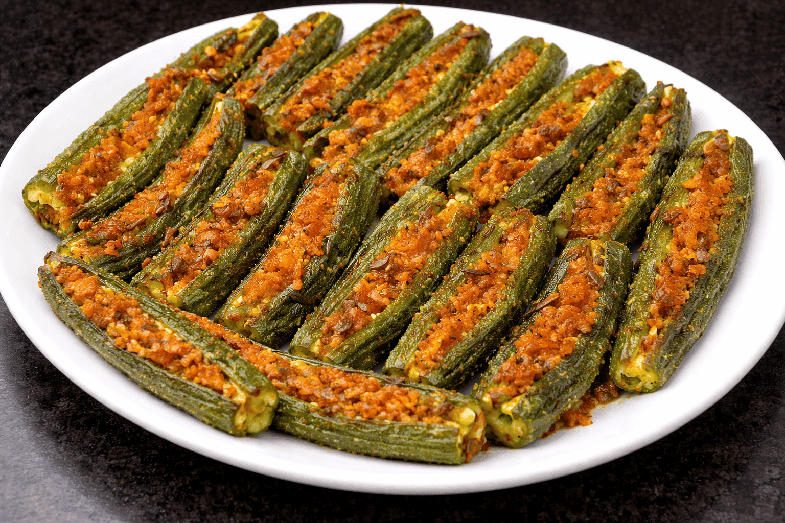 Whole stuffed bhindi okra pods cooked dry with spiced besan filling on a serving dish