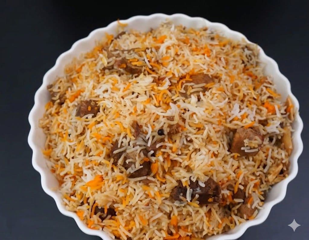 Karachi Beef Biryani with leg-cut beef, aloo bukhara, and birista layered over basmati