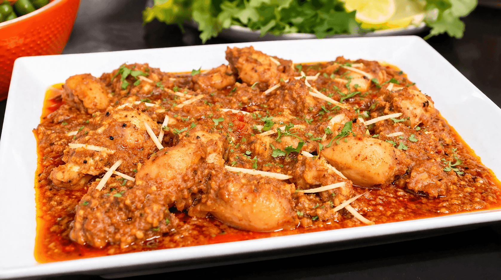 Shadi Wala Chicken Qorma in a deep pot with golden fried onions and whole spices