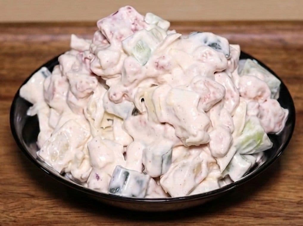 Creamy chicken salad with pineapple, cabbage, and a dairy cream dressing in a bowl
