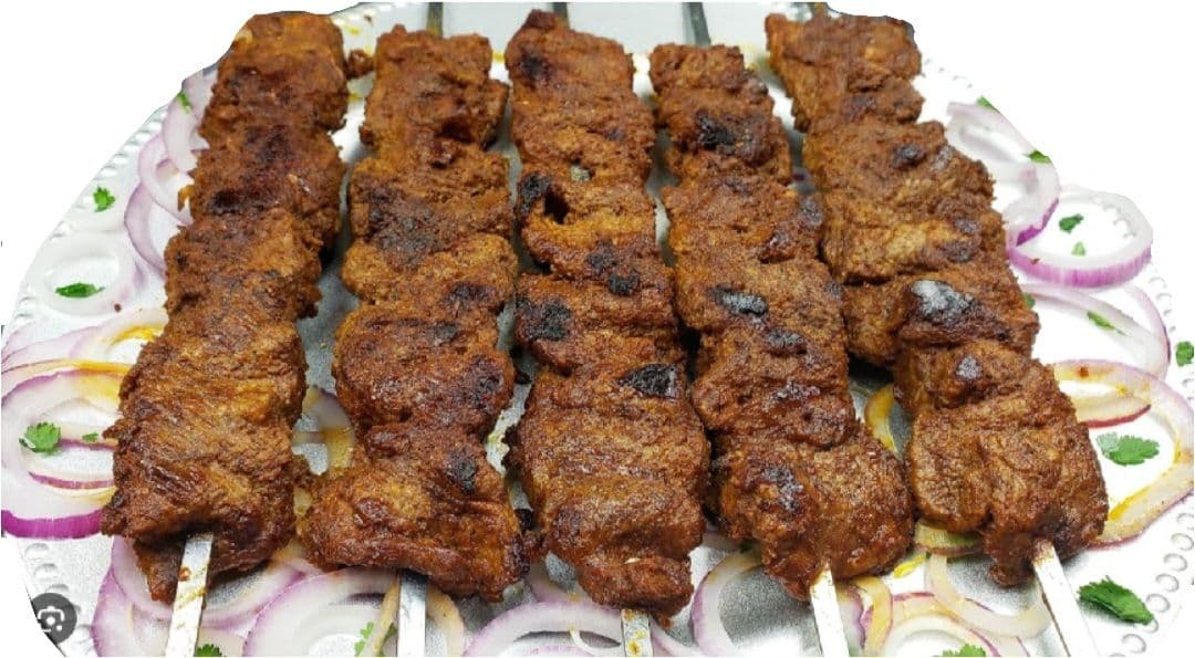 Bihari Beef Kabab strips grilled on skewers with coal smoke and mustard oil marinade